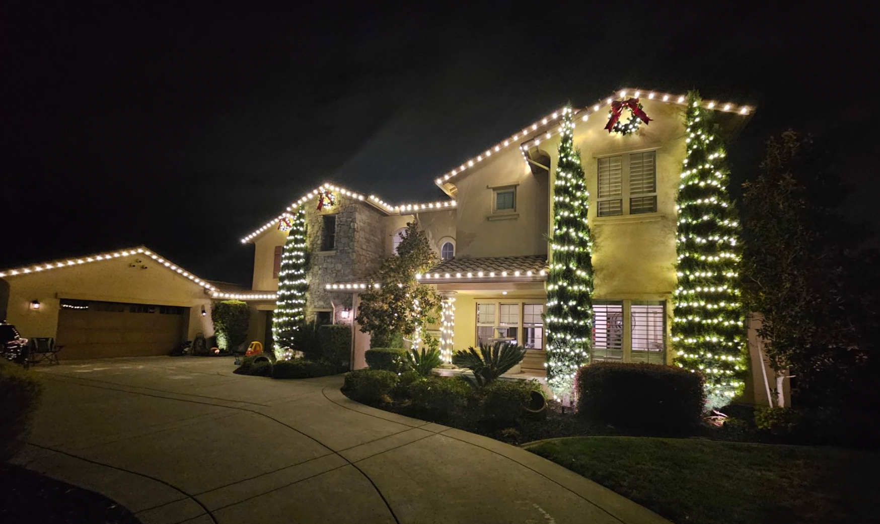 Consistent commercial-grade LED Christmas lights installed across a Sacramento roofline