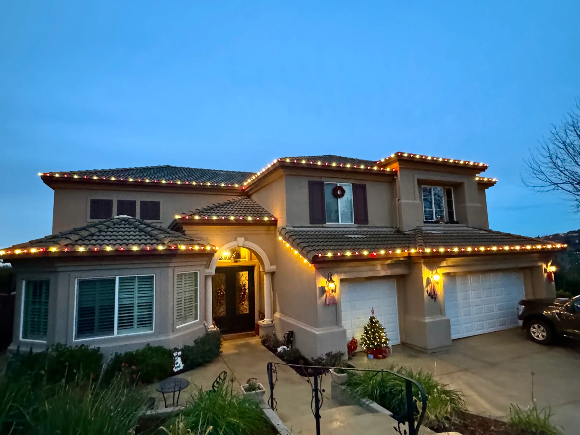 Custom roofline Christmas light installation on a home in Folsom, CA by Santa's Lights