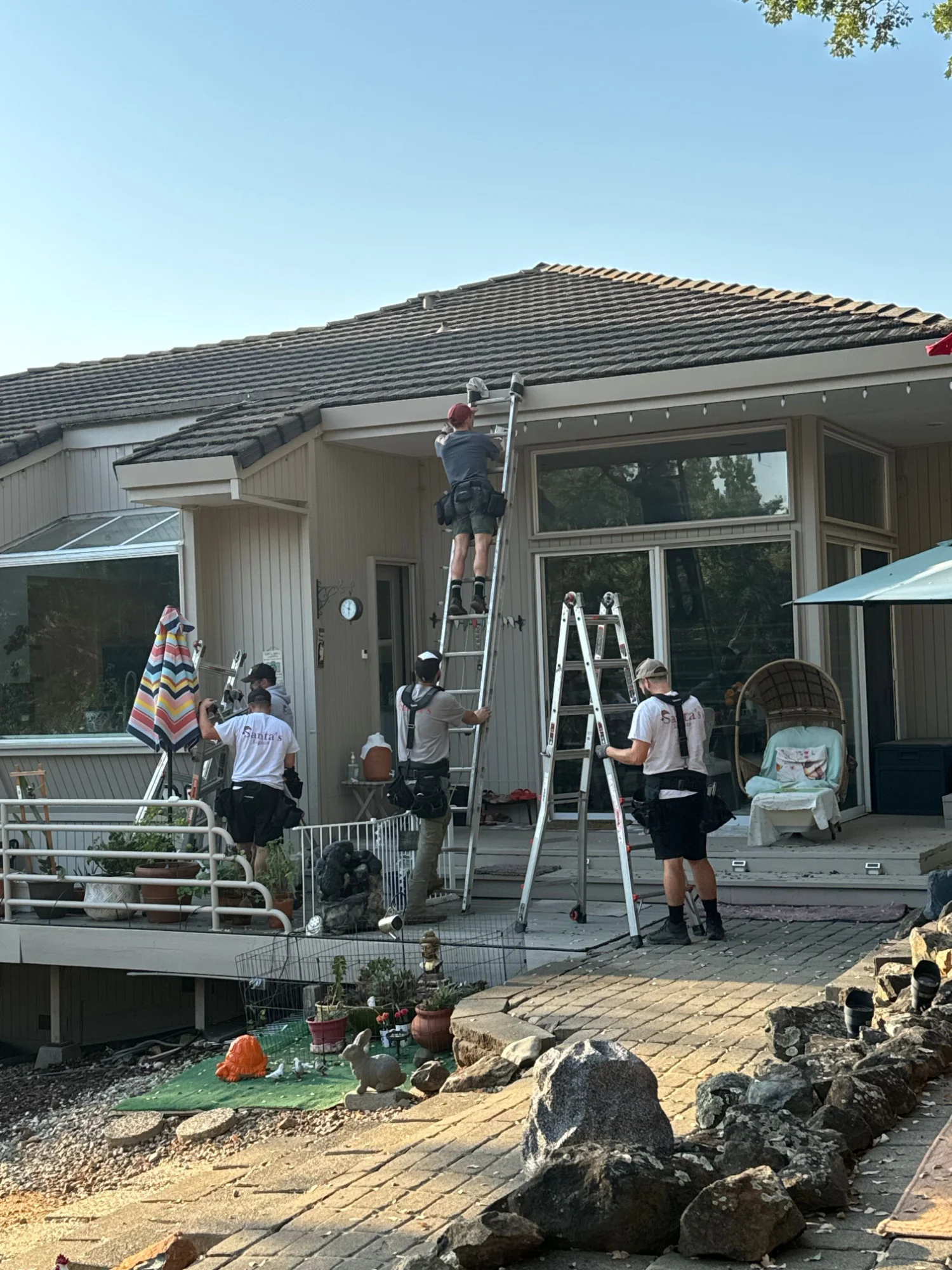 Santa's Lights crew safely working on a tile roof in Elk Grove, Sacramento