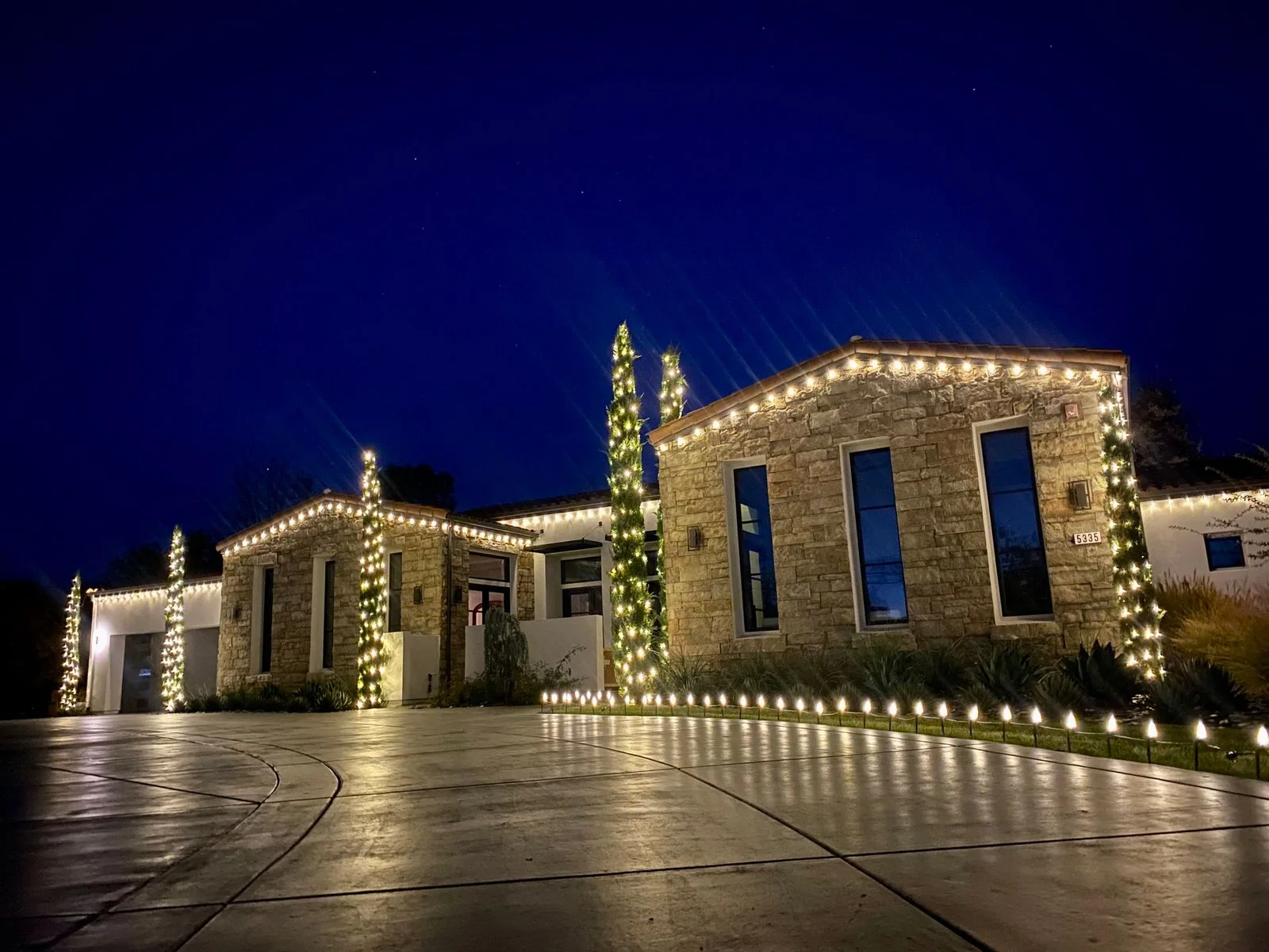 LED Christmas lights safely installed along a Sacramento roofline at night