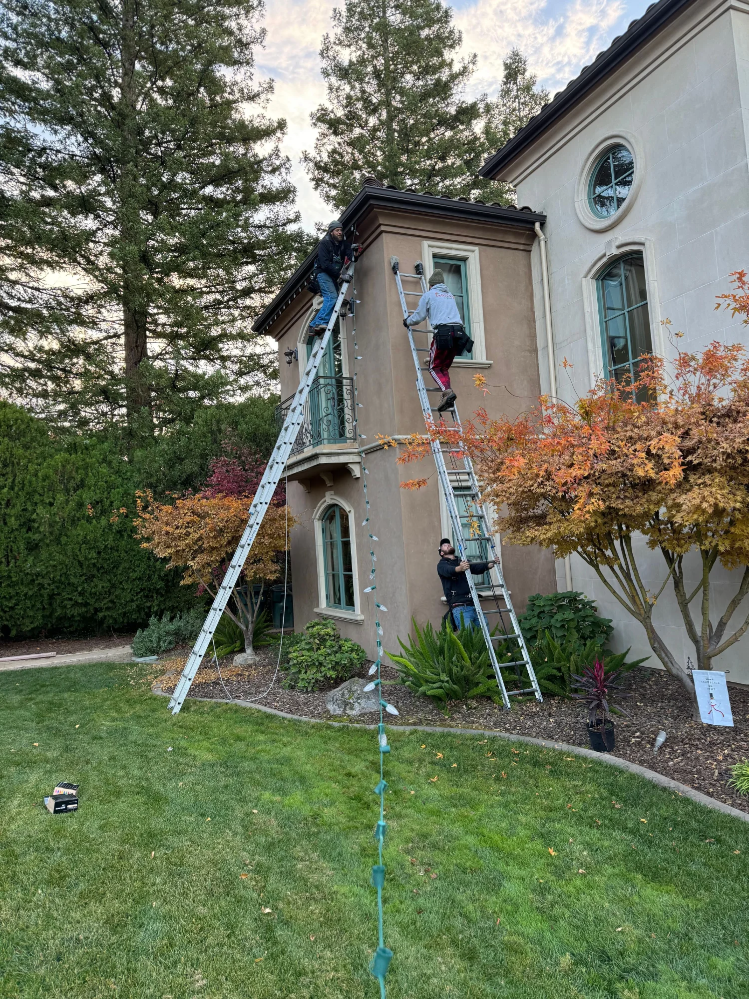 Santa's Lights crew installing Christmas lights on a Sacramento home