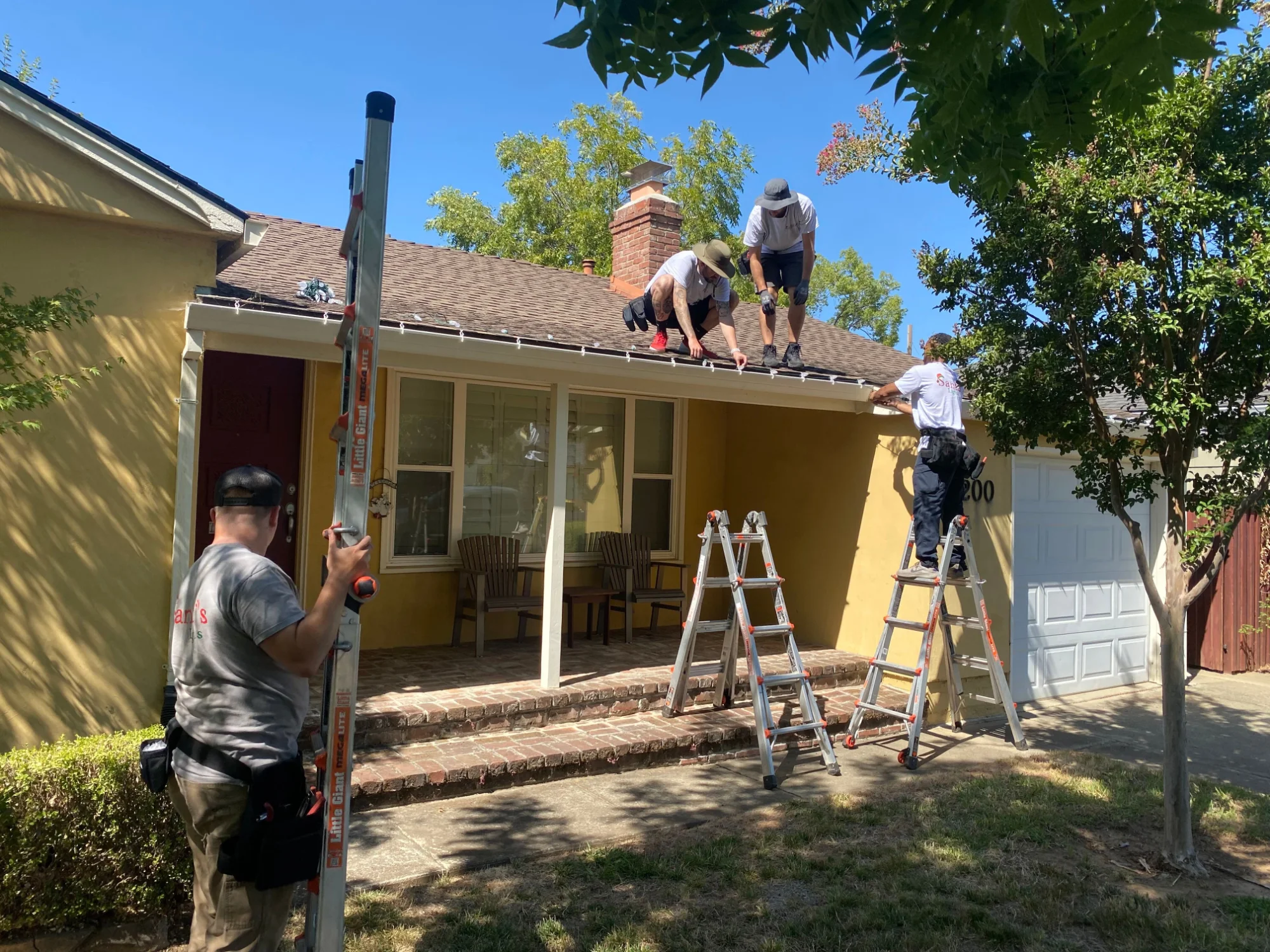 Santa's Lights crew removing Christmas lights from a Sacramento home in January