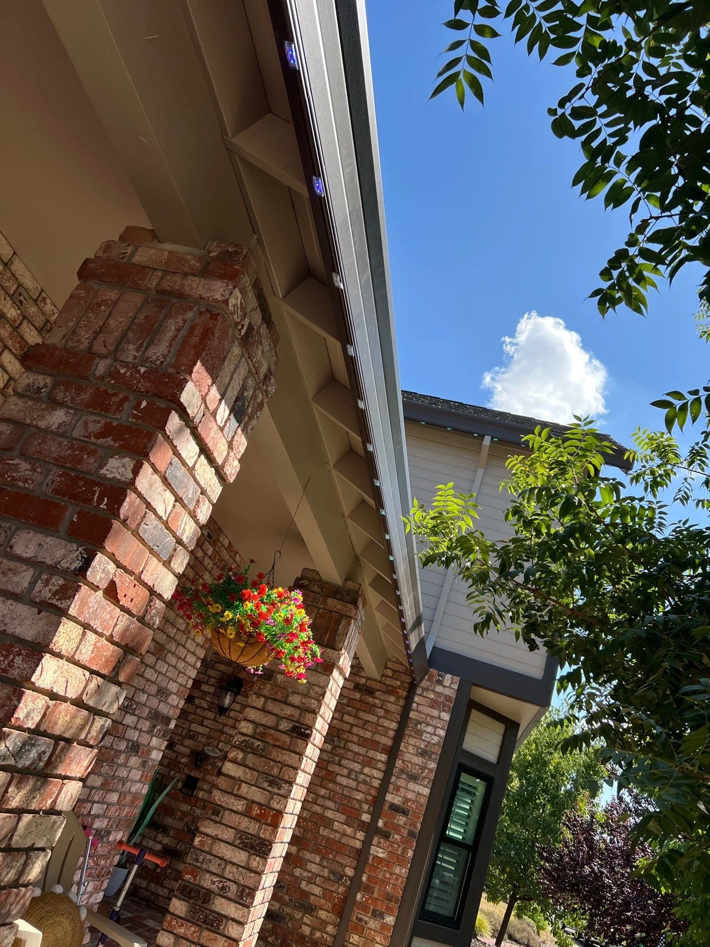 Permanent lighting pebbles lit along the gable of a Tudor style home in Folsom