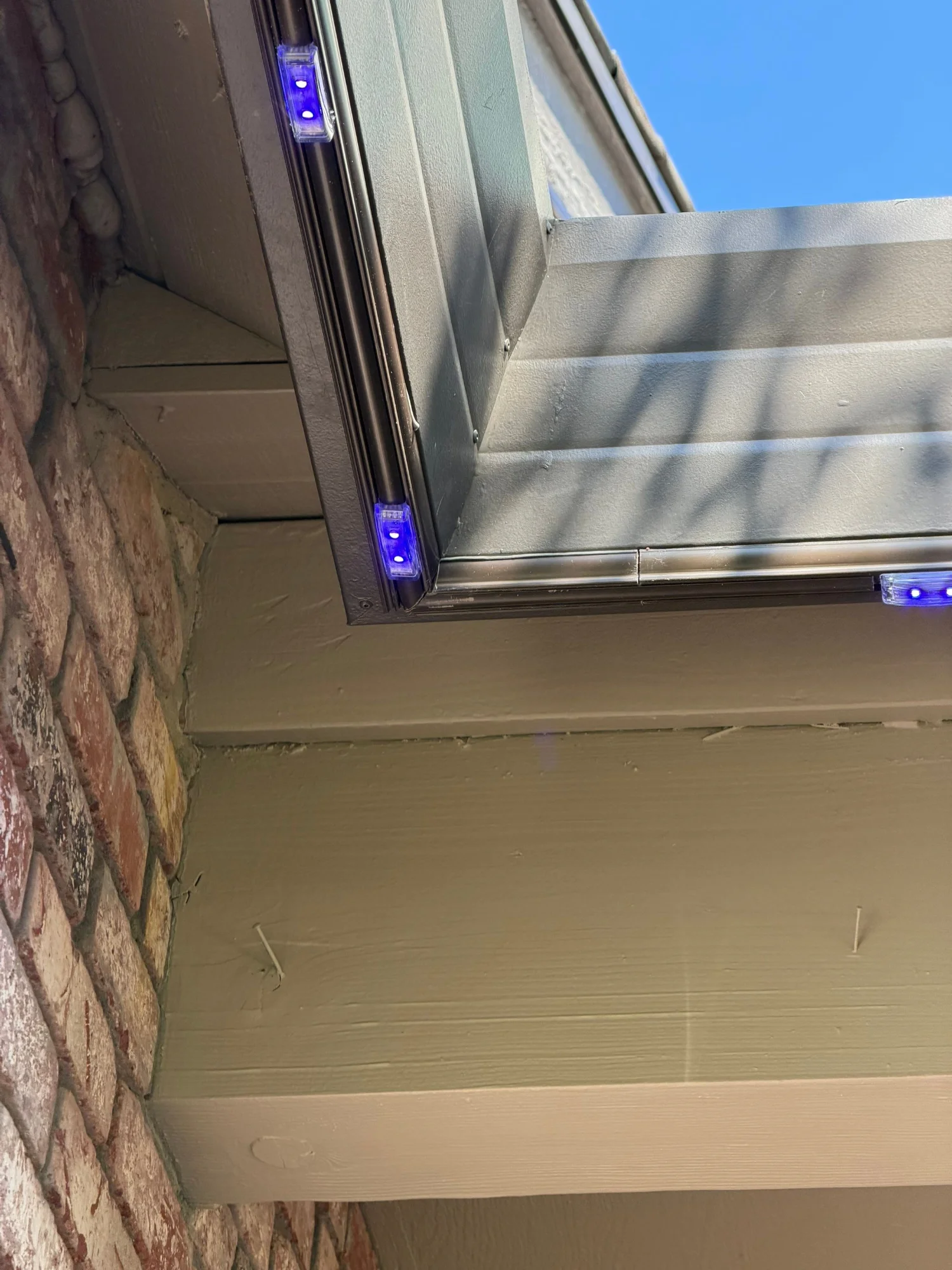 Close up of permanent lighting track turning a corner along the gutter and fascia of a Folsom home