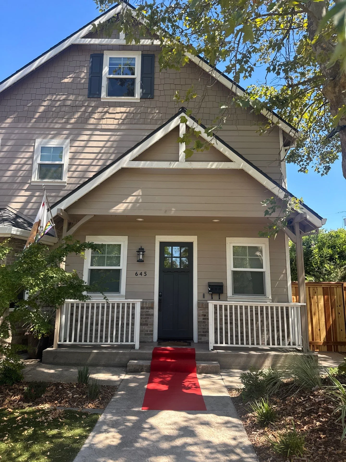 Craftsman style two-story home in East Sacramento, California with a shingled front gable and white trim
