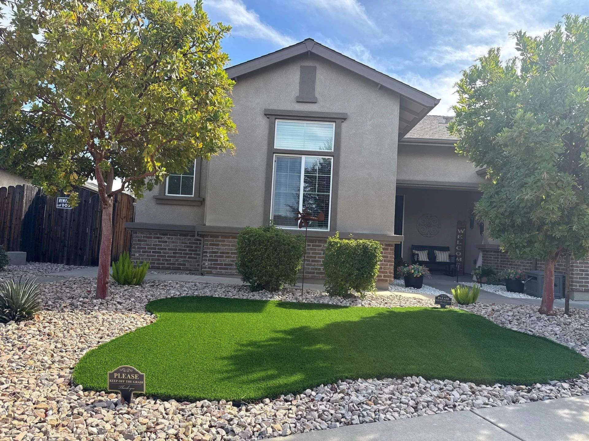 Stucco home with a gabled front and a tree filled front yard in Orangevale, California